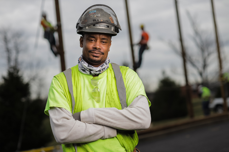 lineworker student in front of students climbing poles