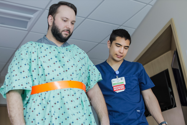 nursing graduate helping paitent in hospital