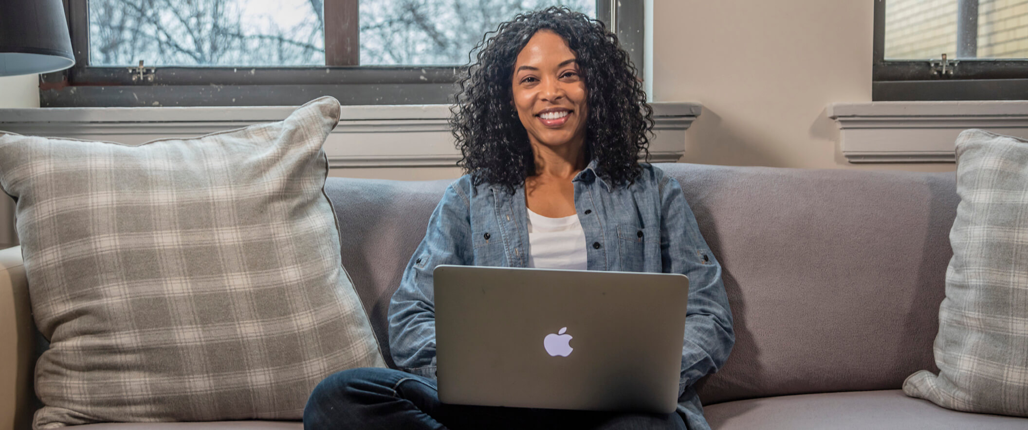 woman on couch with laptop